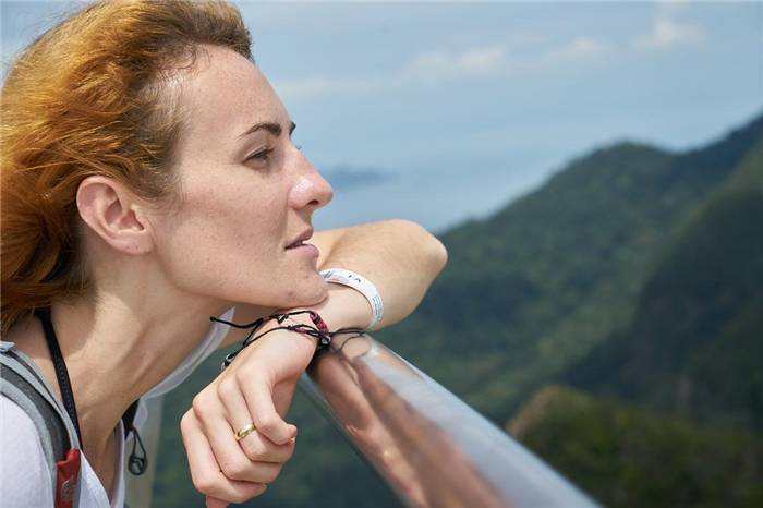 Mädchen an der Reling mit Blick auf die Berge